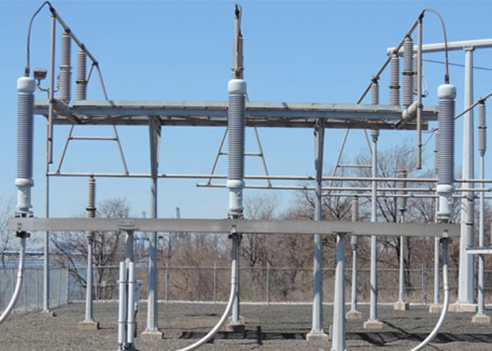 Three large cables in a substation.