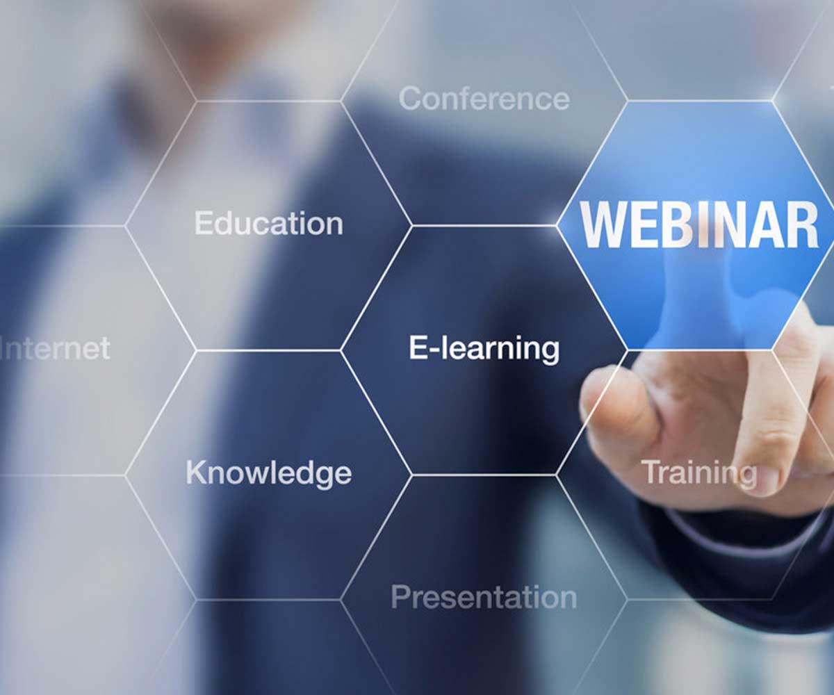 Finger pressing a webinar button