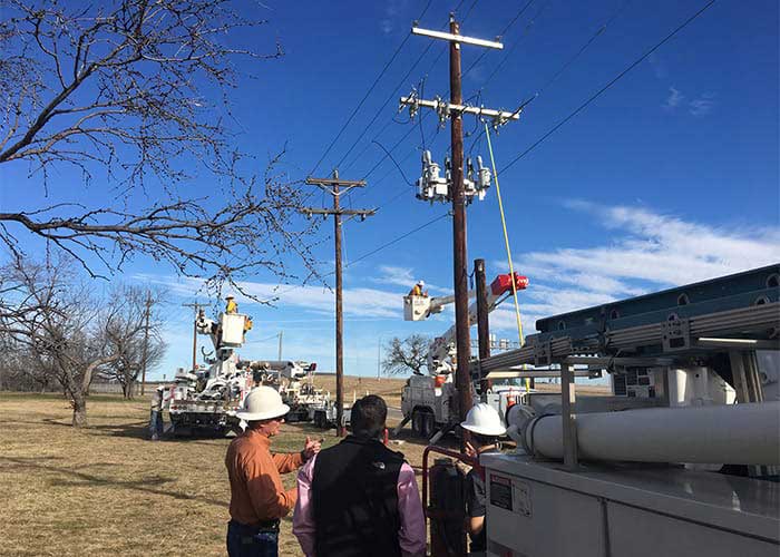 Utility workers in a boom truck